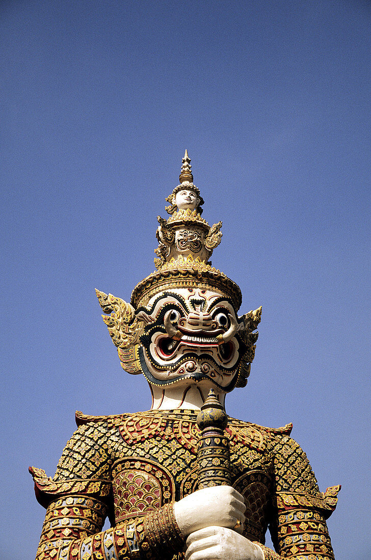 Demon Yaksha statue guarding Wat Phra Keo temple on grounds of the Grand Palace. Bangkok, Thailand