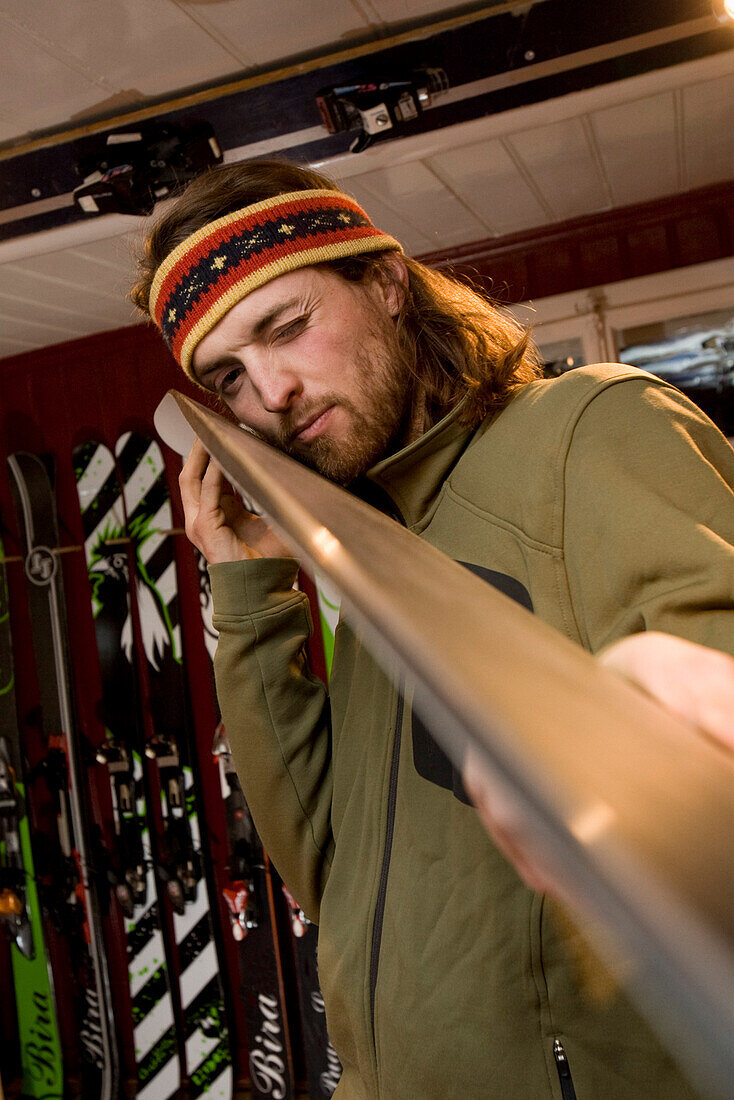 Man checking freeride ski, Andermatt, Canton Uri, Switzerland