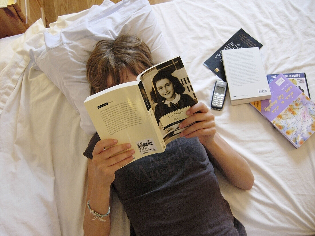 Young girl reading the Diary of Anne Frank