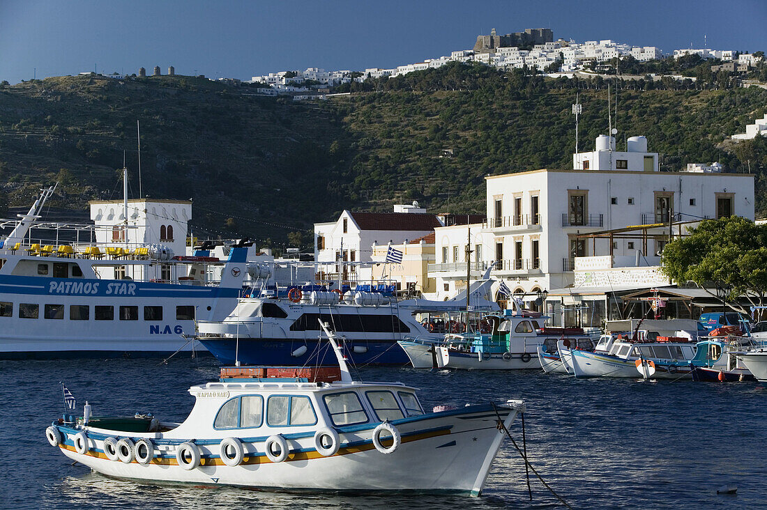 View of Harbor & Hilltop Monastery of St. John the Theologian (12th century). Morning. Skala. Patmos Island. Dodecanese. Greece