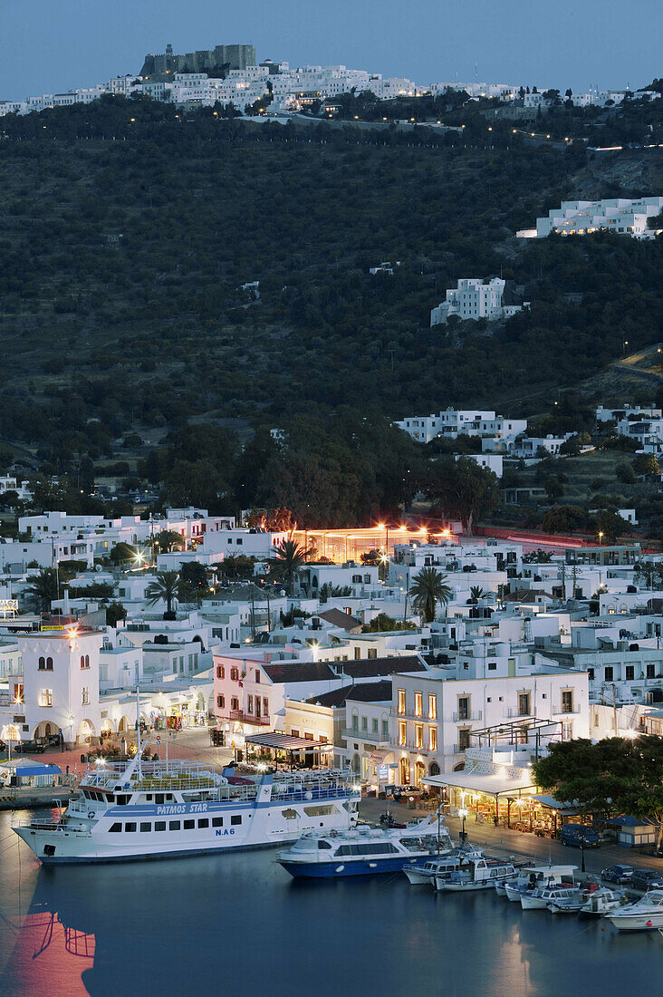 View of Harbor & Hilltop Monastery of St. John the Theologian (12th century). Evening. Skala. Patmos Island. Dodecanese. Greece