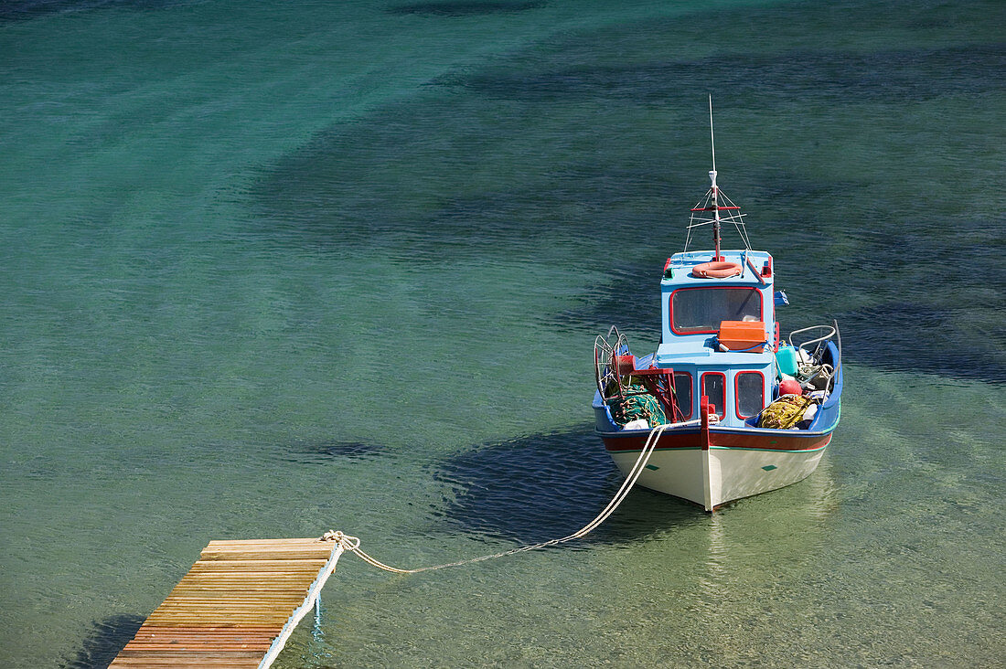 Shore view with small boat. Livadi Geranos Bay. Kampos. Patmos Island. Dodecanese. Greece