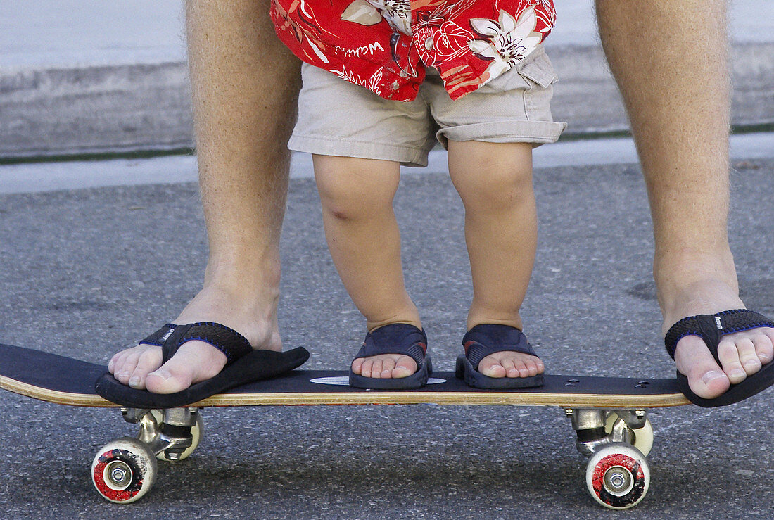 father and son together on skateboard