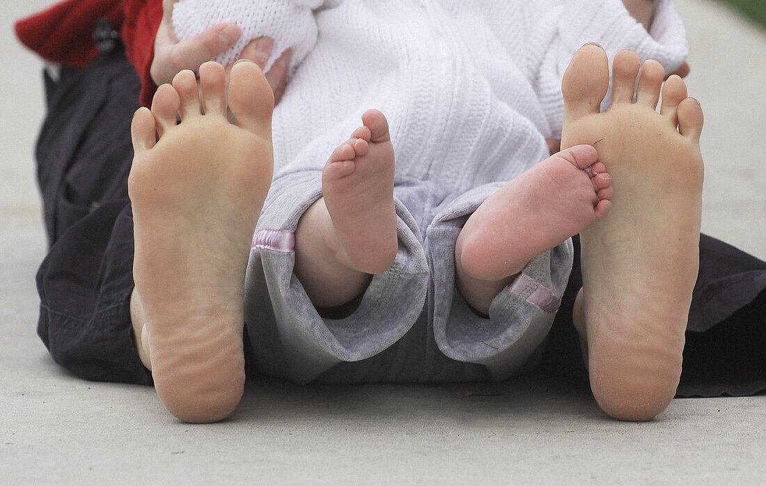 Baby feet and mother s feet