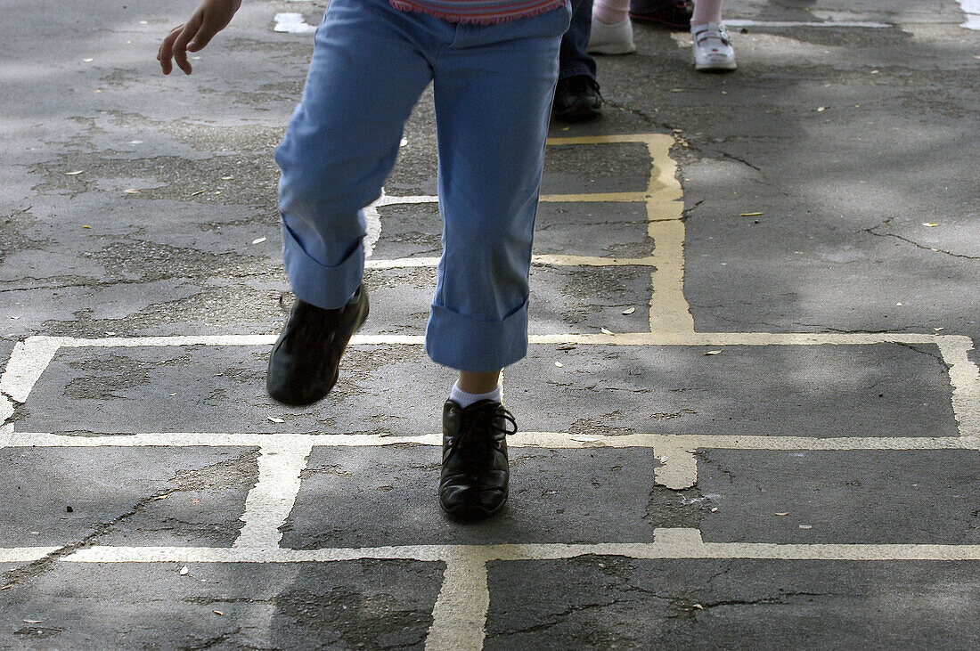 Kids playing hopscotch at school