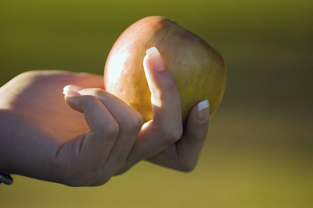 woman holding apple