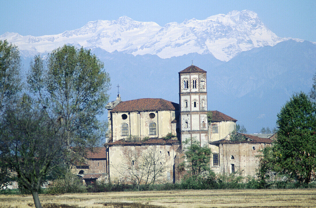 Church with Alps at background. Barolo. Italy