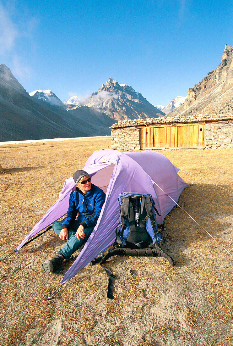 Trekker outside tent. Lhonak (4785mts). Kangchenjunga. Base camp. East Nepal