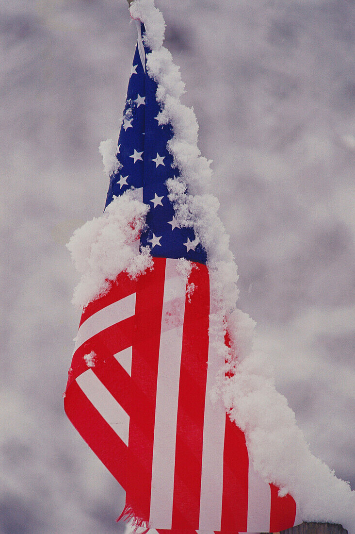 U.S. flag partly furled with snow on it. Monroe County. Indiana. USA