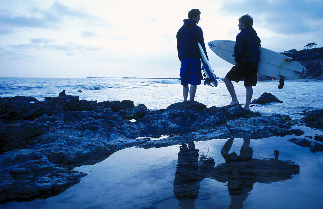 Two surfers at tide pools.