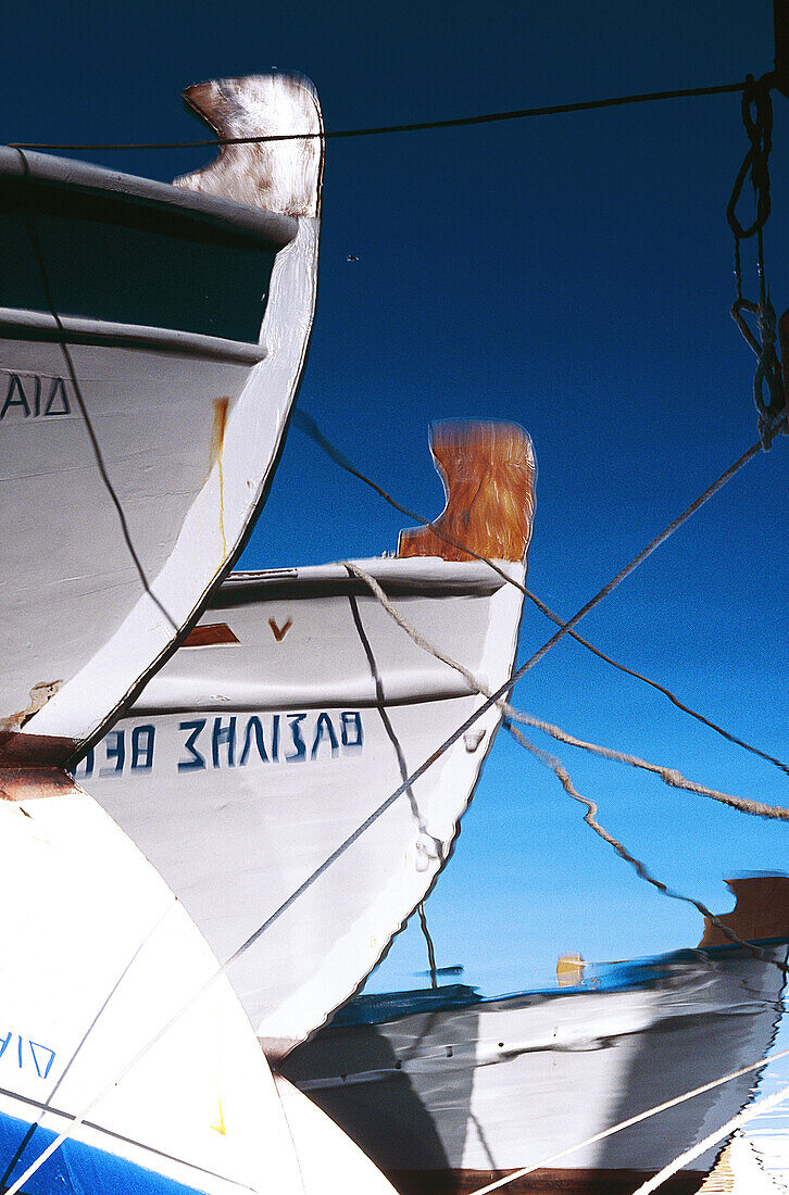 Greece, Cyclades Islands, Paros, Harbour of Naoussa, Fishermen boat reflecting in the sea.