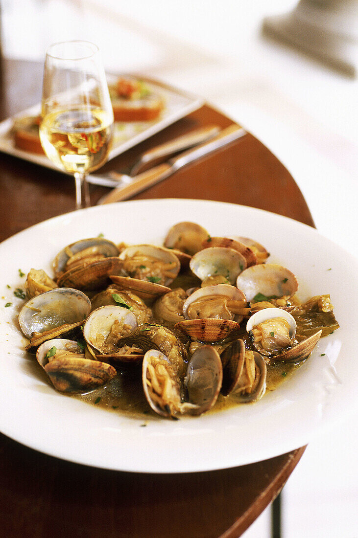 Spain. Andalusia. Jerez. Local cooking tapas, clams, artichokes and Sherry at the restaurant Gallo Azul