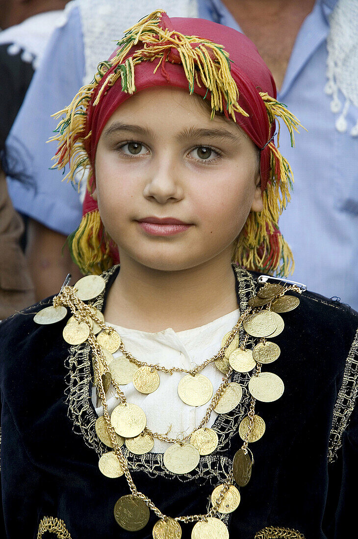 Young girl attending a wedding. Anogia. Crete. Greece.