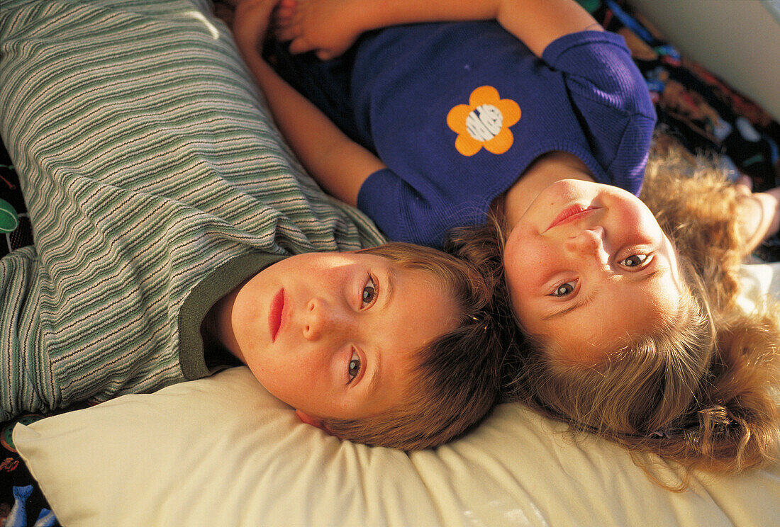 Brother and sister on bed