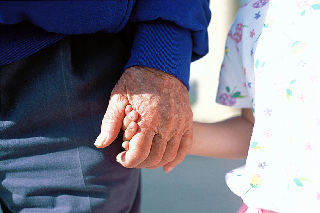 Grandfather holding hands with granddaughter