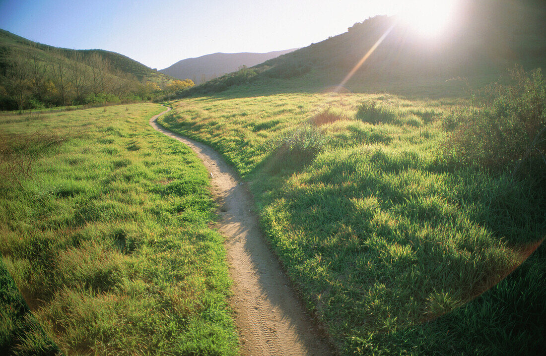 Sunset path through the hills