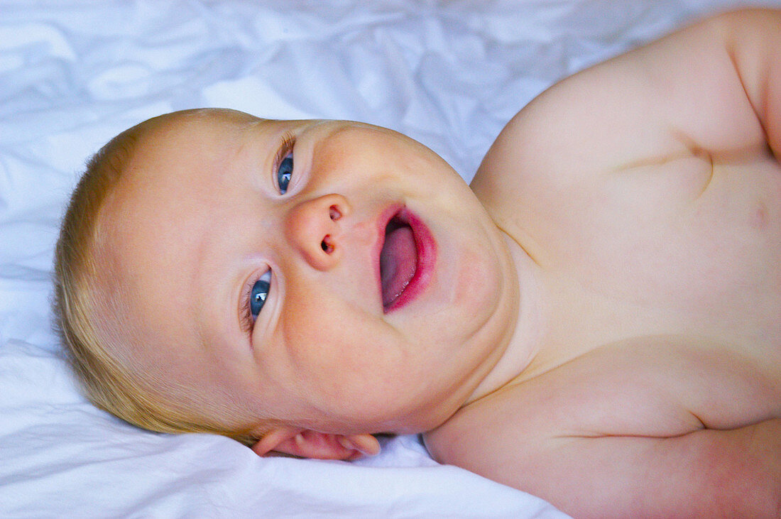 happy baby on bed