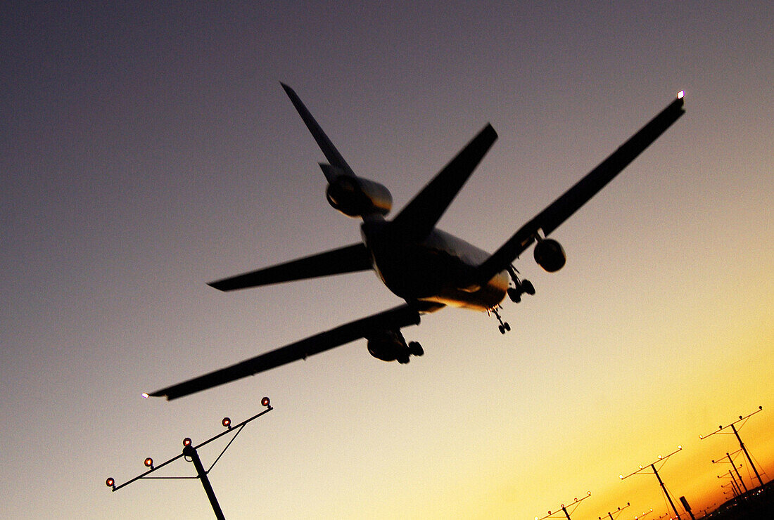 sunset plane landing at airport