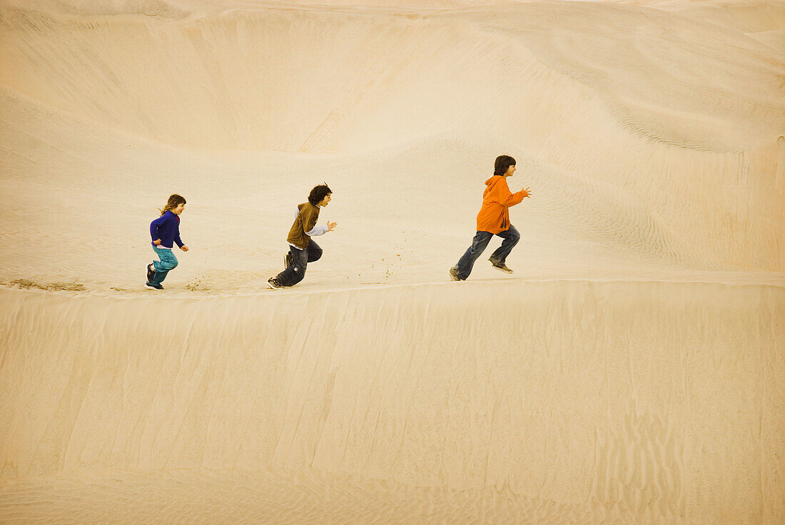 Children run on Sand Dunes, Baja California, Mexico