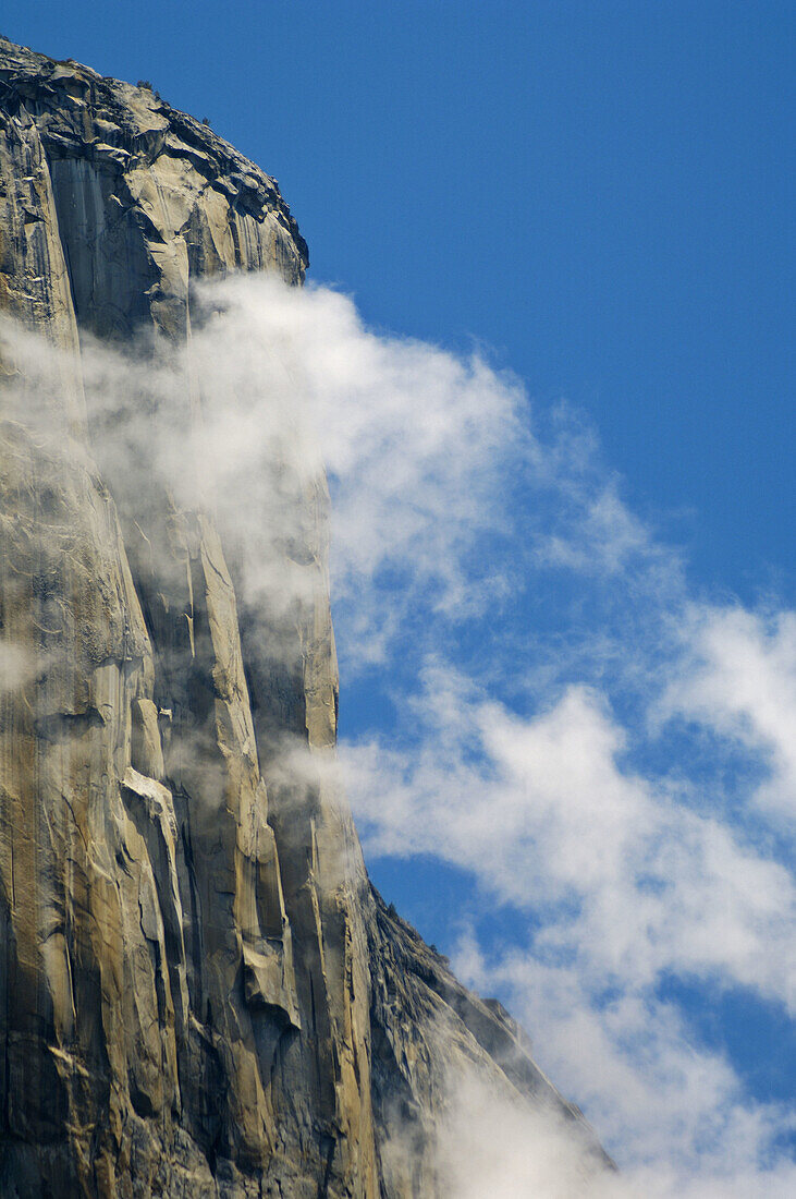 Clouds forming near the summit and sheer cliff walls of El Capitan, Yosemite Valley, Yosemite National Park, California