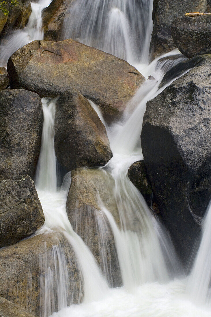 Detail close-up of water flowing off rocks in Cascade Creek during spring runoff, Yosemite National Park, California
