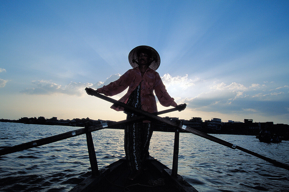 Rower in traditional river boat. Mekong Delta. Vietnam