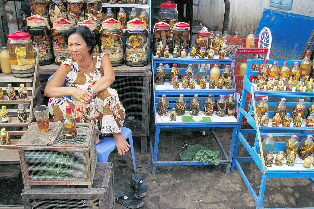 Snake vendor at market. Vinh Long. Vietnam