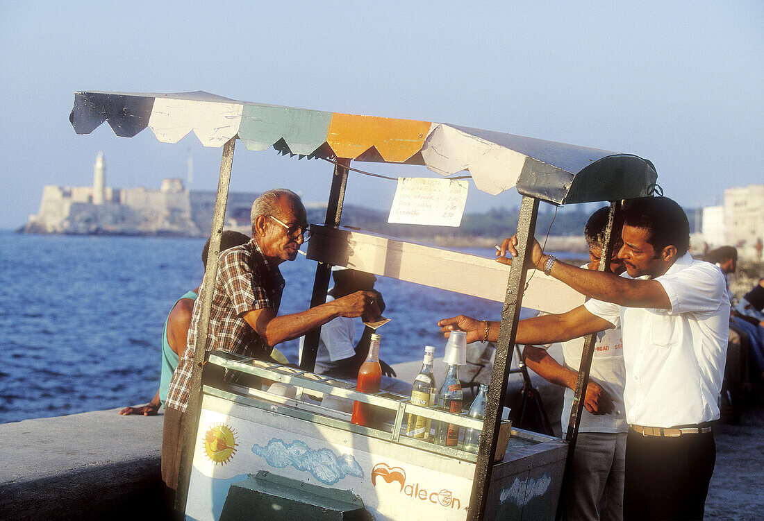 Man selling drinks by waterfront. Havana. Cuba