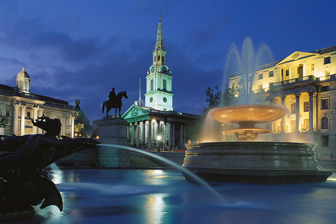 Fountain at Trafalgar Square, Saint Martin in the Fields church in background. London. England