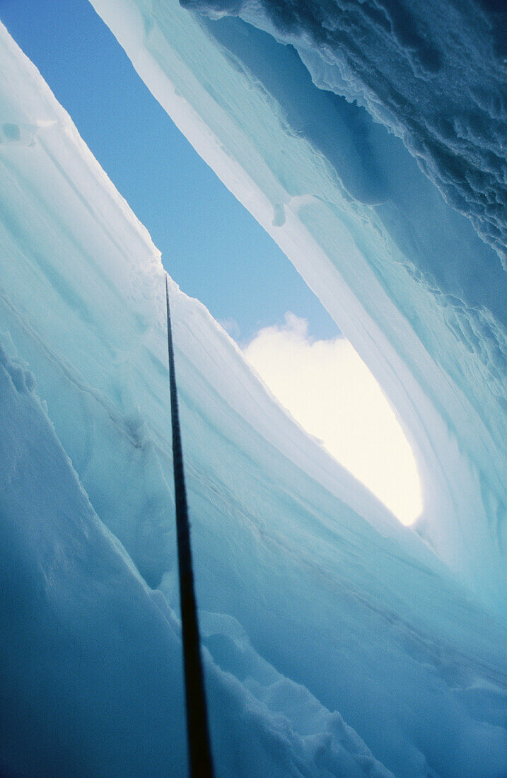 Crevasse in Coleman Glacier, view up climbing rope to sky. Mount Baker Wilderness. Washington. USA
