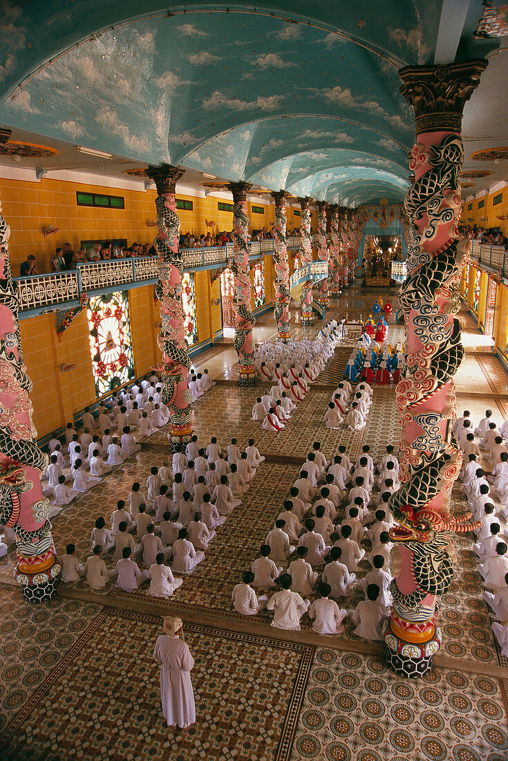 Worshipers at service in the Cao Dai Great Temple. Tay Ninh. Vietnam