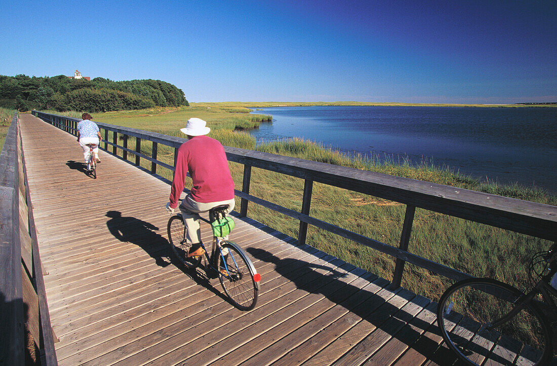 Couple riding bicycles. Eastham. Cape Cod. MA. USA