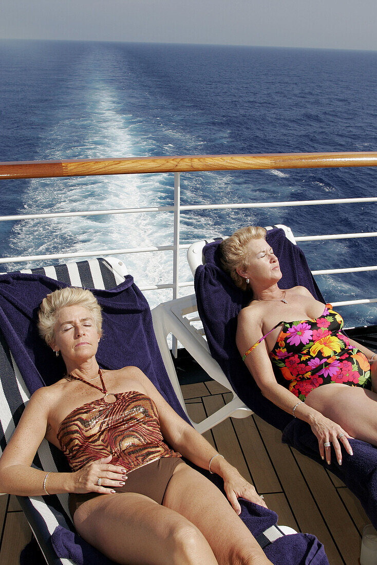  Adult, Adults, Baby boomer, Baby boomers, Basking, Bathing suit, Bathing suits, Calm, Calmness, Caucasian, Caucasians, Chill out, Chilling out, Closed eyes, Color, Colour, Contemporary, Cruise, Cruises, Daytime, Deck, Decks, Exterior, Facial expression, 