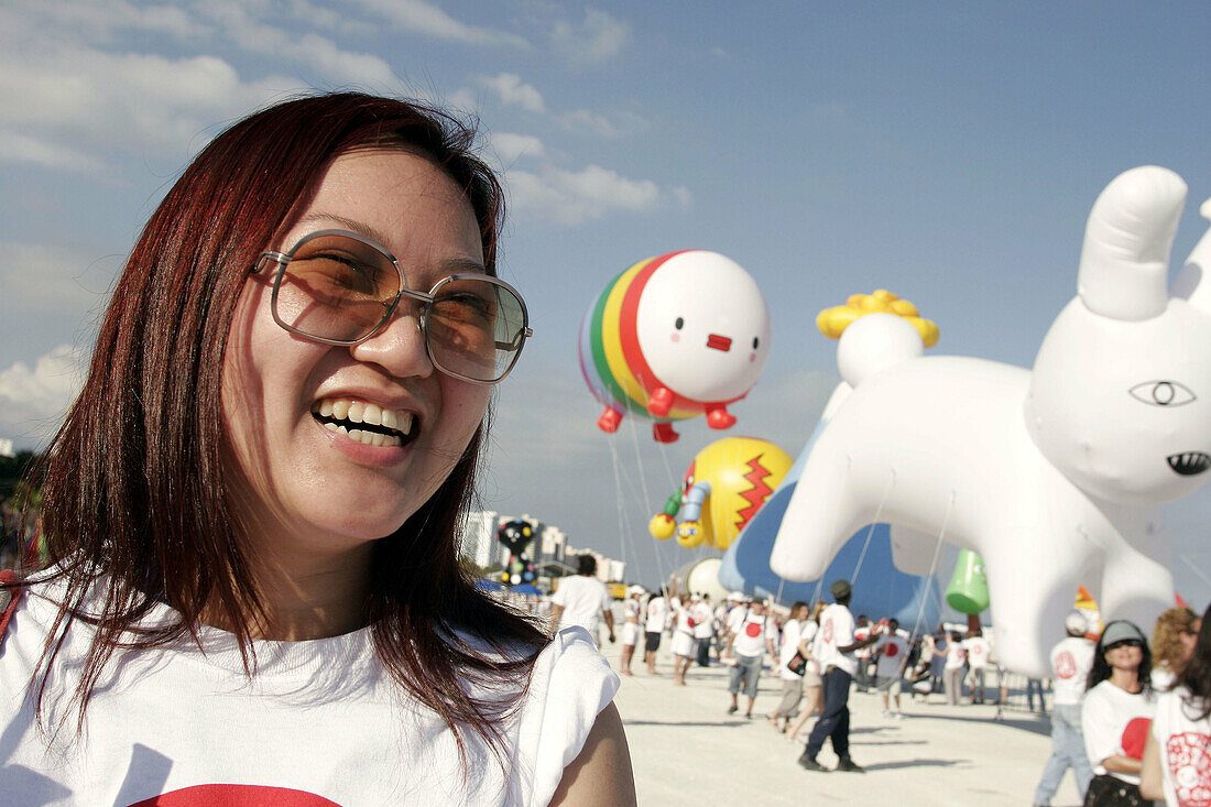 ArtCenter South Florida benefit, Asian female. Skywalkers Giant Blimp Parade. Atlantic Shore. Miami Beach. Florida. USA.