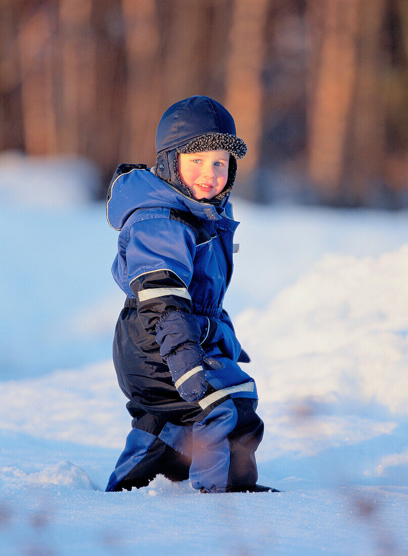 Little boy walking on snow. Västerbotten, Sweden