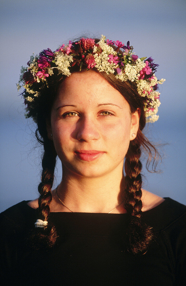 Girl with a wreath made of flowers on Midsummer s Eve. Västerbotten, Sweden