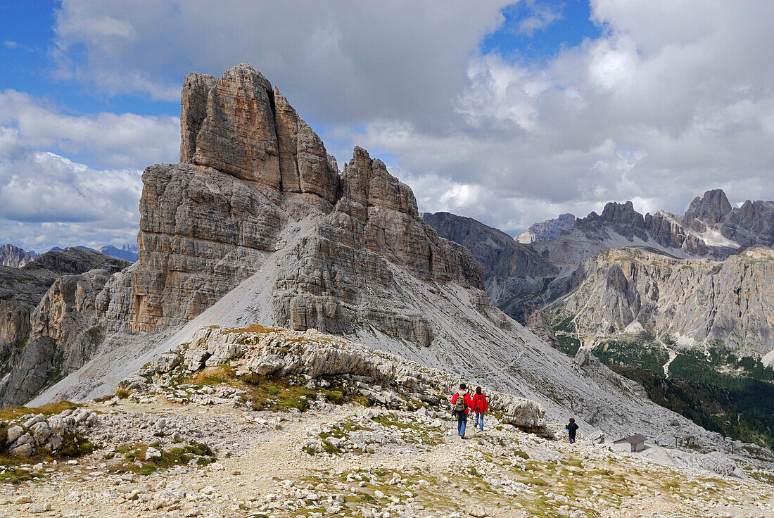 Two hikers in front of Averau, Alta Via delle Dolomiti number one, Dolomites, Cortina, Venezia, Italy