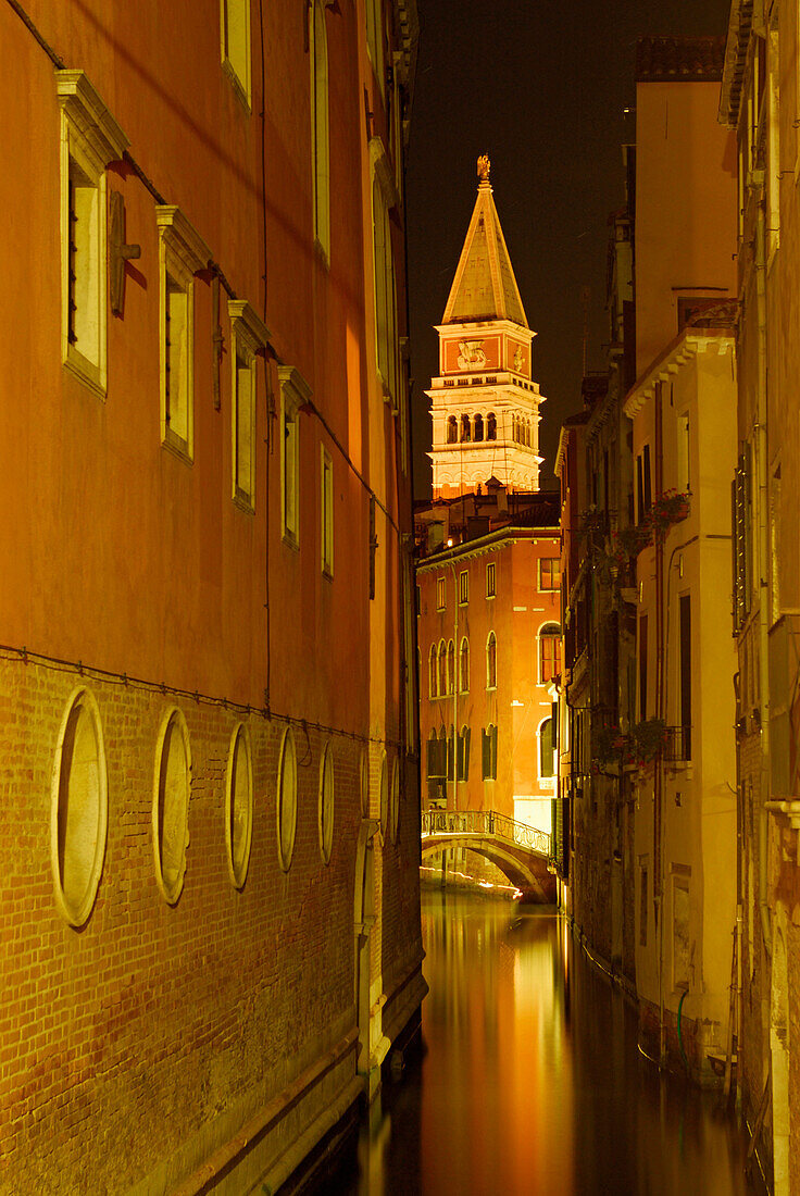 Canal between houses, bridge and spire at night shot, Venice, Venezia, Italy