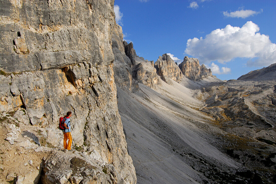Woman descending Forcella di Lech, Lagazuoi grande in background, Dolomites, South Tyrol, Italy
