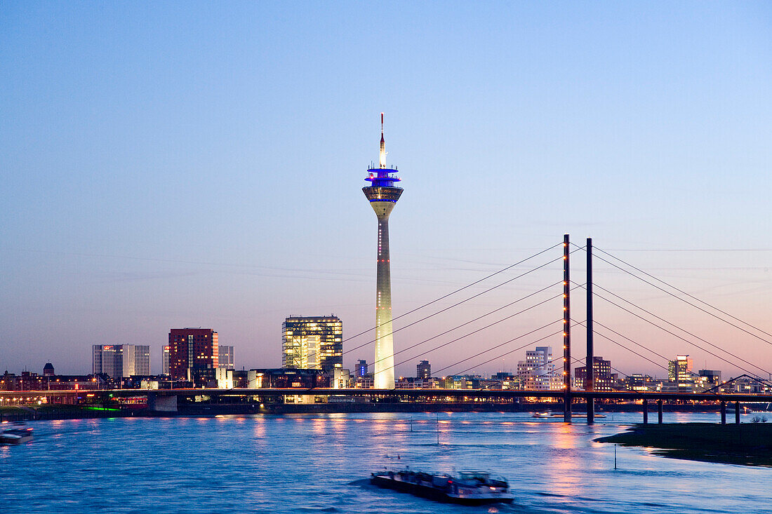 View arcoss river Rhine to Media Harbour and Rheinturm Tower in the evening, Dusseldorf, North Rhine-Westphalia, Germany