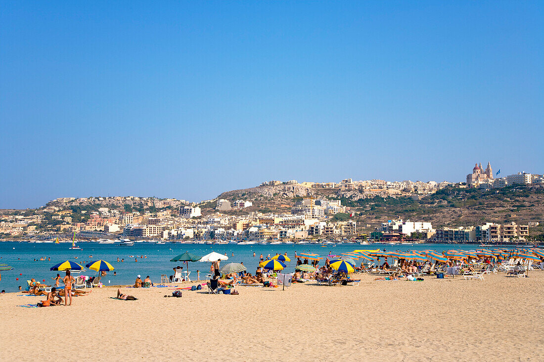 People at the beach under blue sky, Mellieha Bay, Malta, Europe