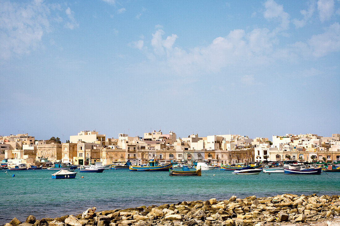 View at boats at harbour in front of the houses of Marsaxlokk, Malta, Europe