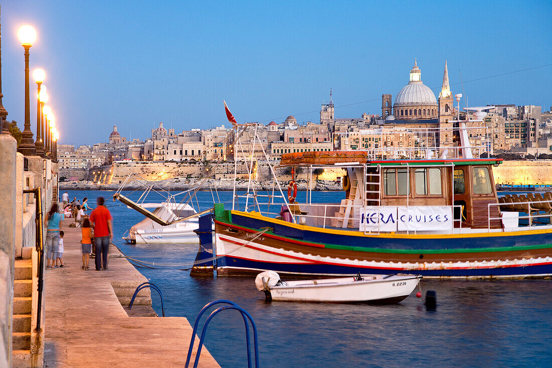 People on the promenade in the evening, view at the town of Valletta, Sliema, Malta, Europe