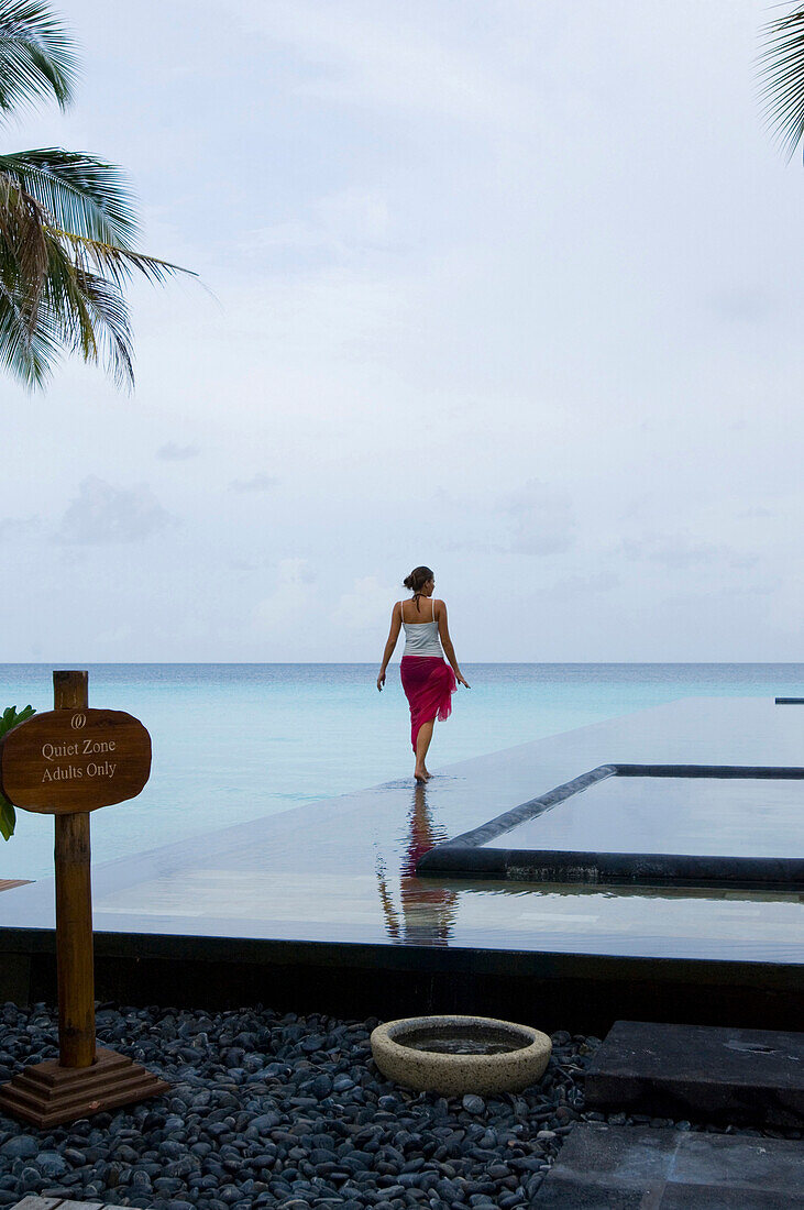 Woman walking near the pool, One & Only Resort Reethi Rah, Maldives, no MR
