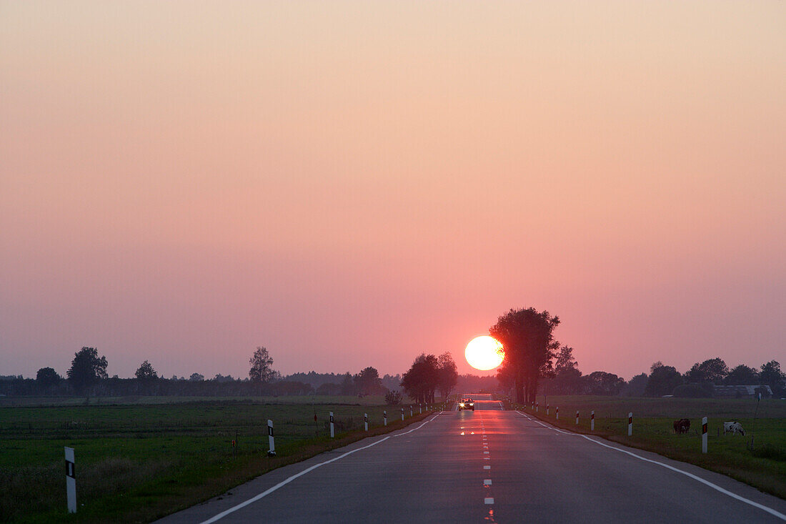Sunset over country road in the district of Telsiai, Lithuania