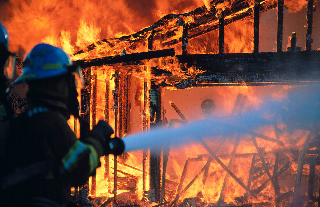 Firemen extinguishing a burning house
