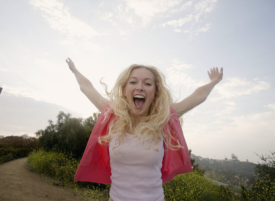 Happy girl screams out her joy, Los Angeles, CA, USA