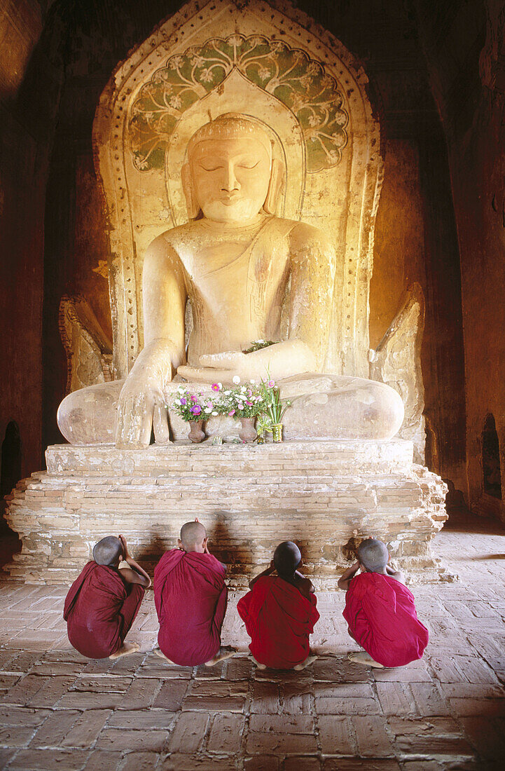 Novice monks praying buddha. Bagan. Myanmar (Burma)