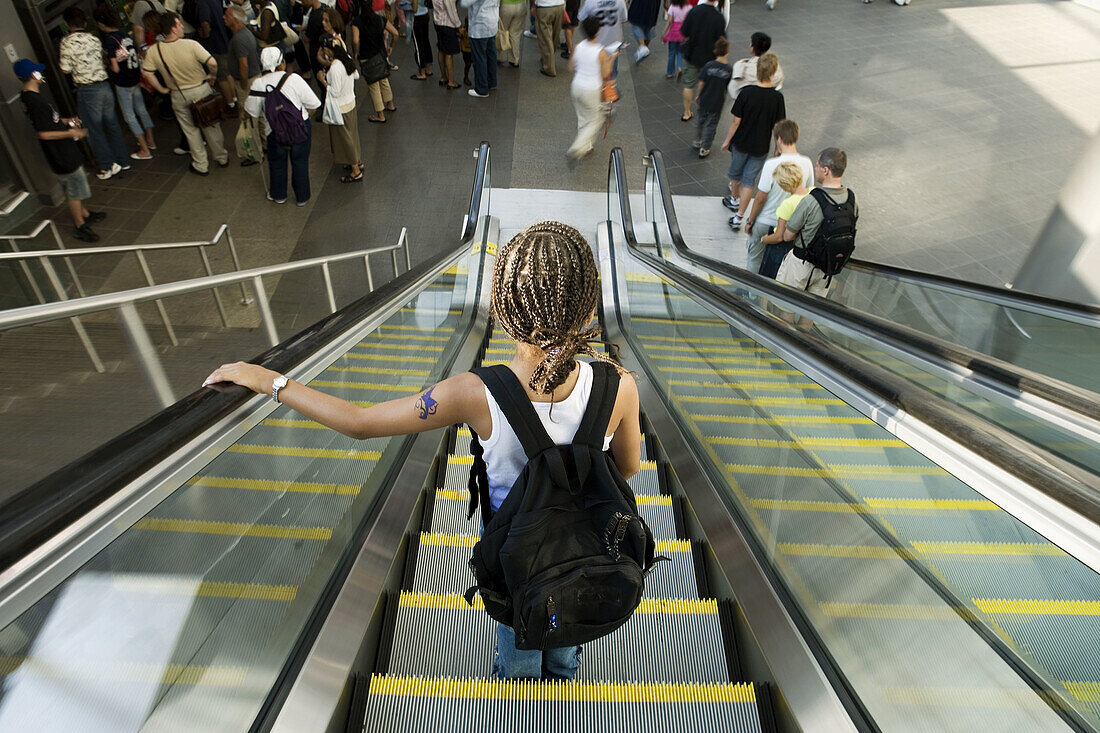 Afroamerican girl on escalator. New York. USA.