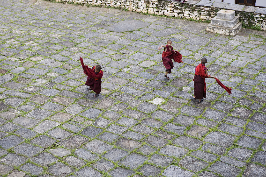 Bhutan. Paro. Paro Dzong Monastery. Little buddhist monks playing